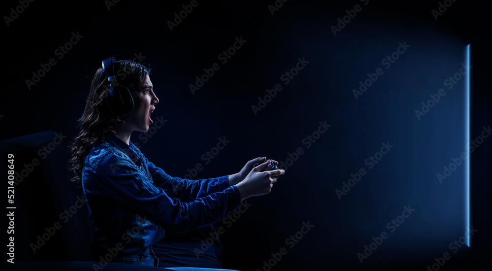 A woman in headphones with a controller set aside in her hands A woman in headphones with a controller set aside in her hands