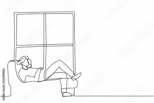 Single one line drawing young man lying on windowsill at home. Male resting in room near window. Spending time at home, relaxing after work, reading. Continuous line graphic design vector illustration