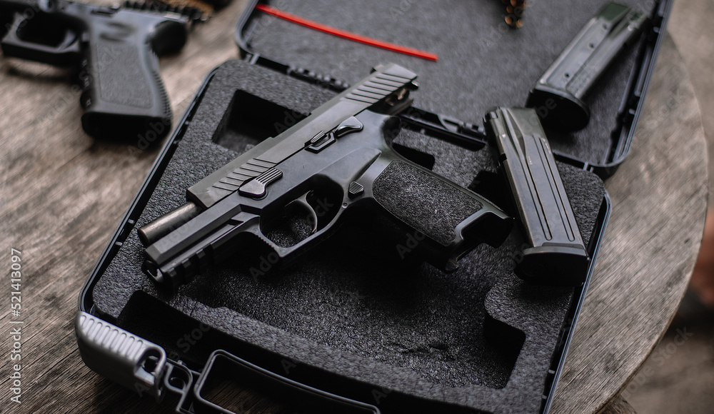 Disassembly and cleaning Maintaining a 9mm semi-automatic pistol on a wooden table. Disassembly and cleaning Maintaining a 9mm semi-automatic pistol on a wooden table.