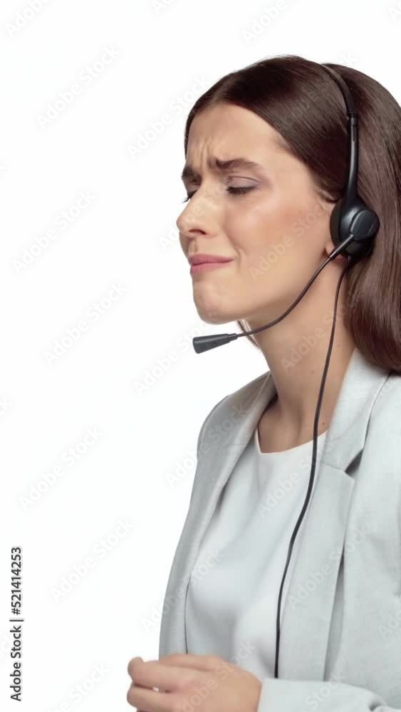 vertical video of displeased operator in headset talking isolated on white
