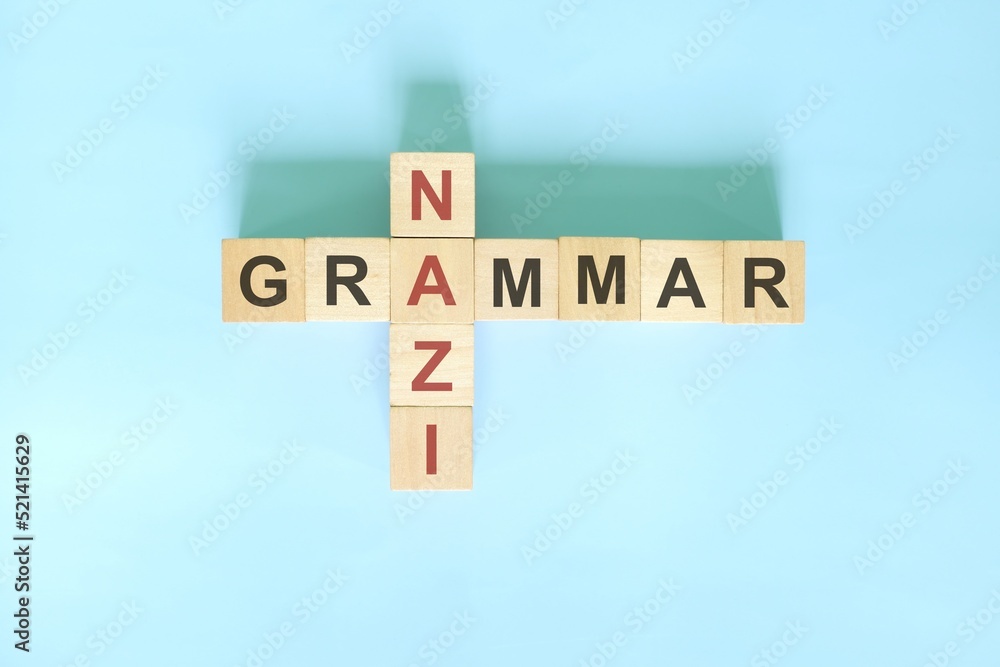 Grammarconcept Wooden block crossword puzzle flat lay in blue Grammarconcept Wooden block crossword puzzle flat lay in blue