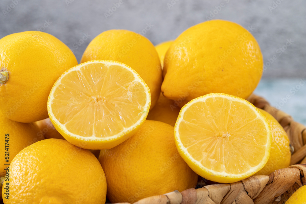 Fresh lemon. Organic lemons in a basket on a stone background. close up Fresh lemon. Organic lemons in a basket on a stone background. close up