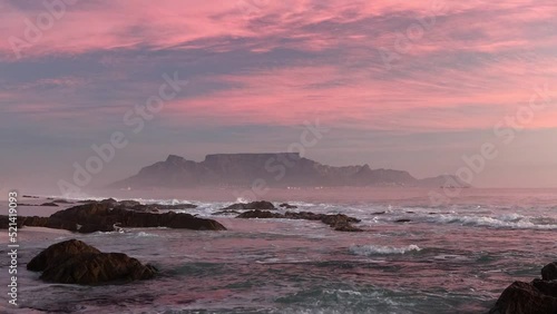 scenic view of tourist landmark destination table mountain cape town south africa from bloubergstrand with crushing waves at sunset photo