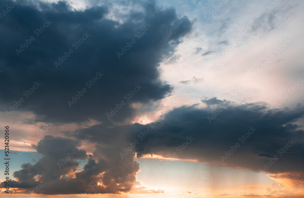 Beautiful landscape of sunset with dark colourful clouds. Natural background.
