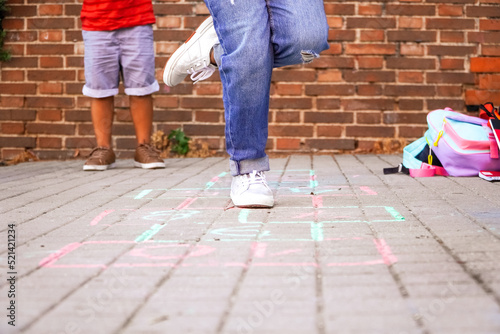 multiethnic kids playing hopscotch on school playground. back to school concept.