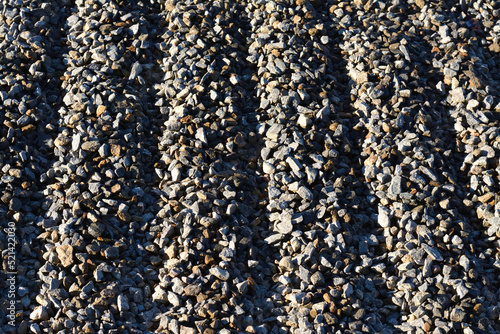 small gravel in the sun's rays texture