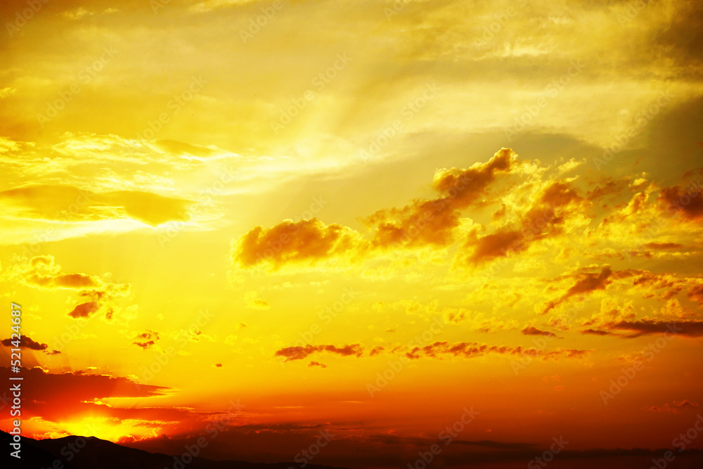 Yellow orange sunset view. Beautiful evening sky with clouds. Colorful background with space for design.