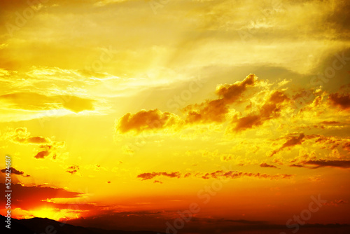 Yellow orange sunset view. Beautiful evening sky with clouds. Colorful background with space for design. © Наталья Босяк