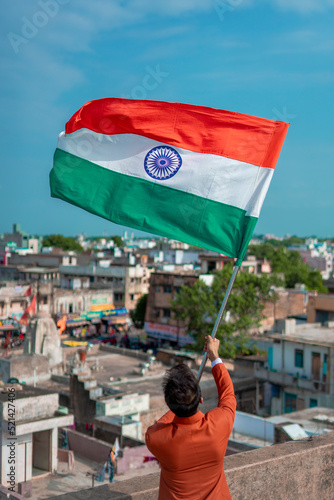  indian young man holding tricolour flag, independence day photo