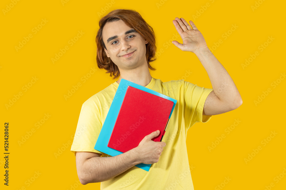 Young man Prep Student with long hair. Portrait of a guy on a yellow background Young man Prep Student with long hair. Portrait of a guy on a yellow background