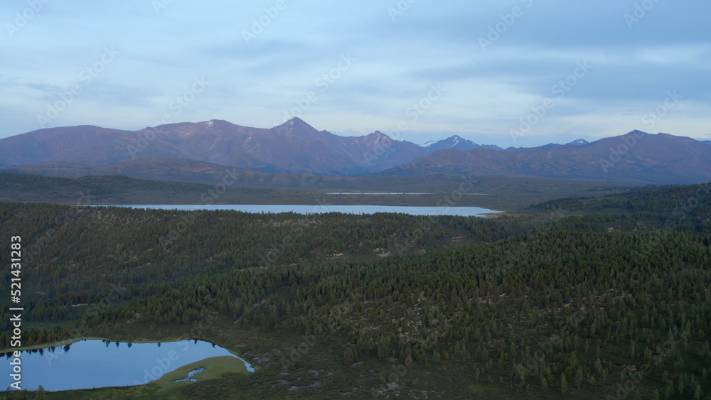 Valley of lakes with mountains and dramatic sky in Altai in evening time