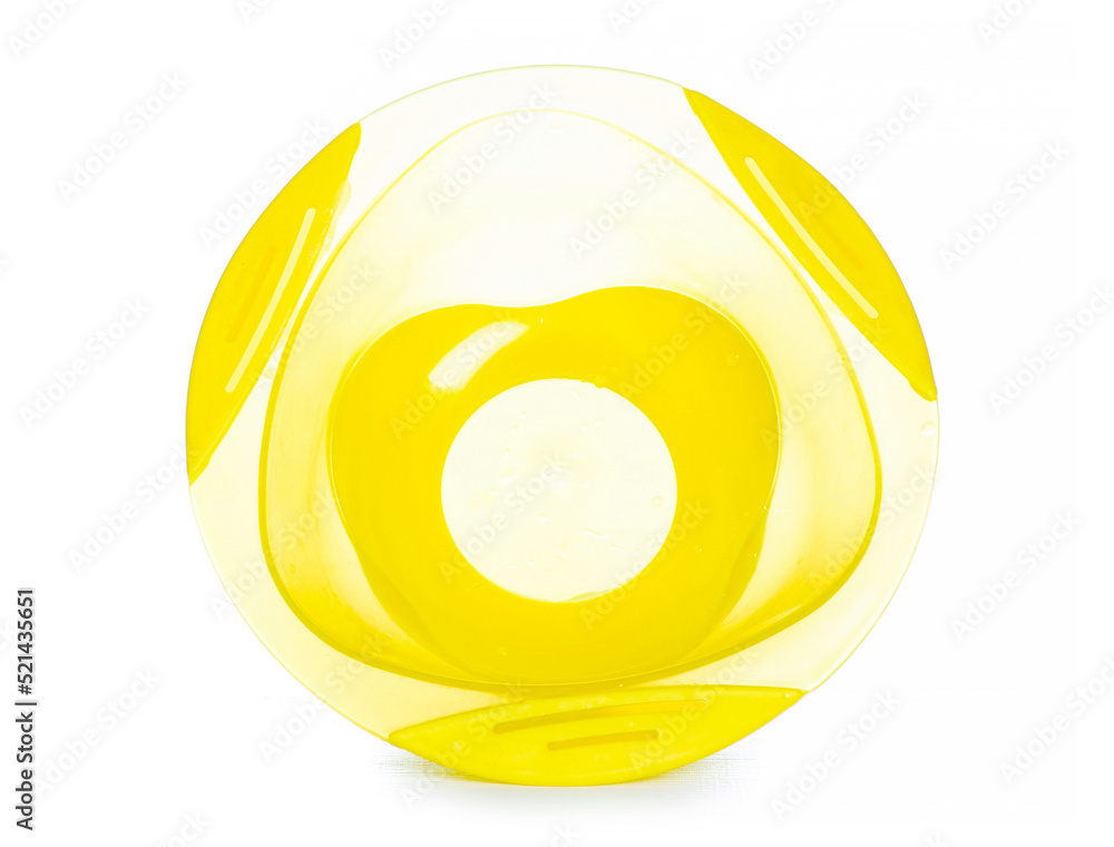 Yellow baby plastic plate with a suction cup on white background isolation Yellow baby plastic plate with a suction cup on white background isolation