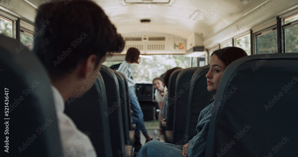 High school students sitting communicating in schoolbus. Pupils waving friend. High school students sitting communicating in schoolbus. Pupils waving friend.