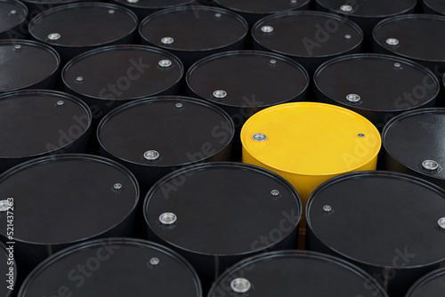 Yellow metal barrel among many black barrels, 3d render