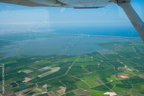 Aerial photo from flying light aircraft over fields Spain Valencia.