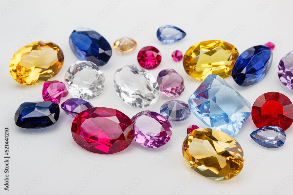 A scattering of precious stones on a light background, close-up. A scattering of precious stones on a light background, close-up.