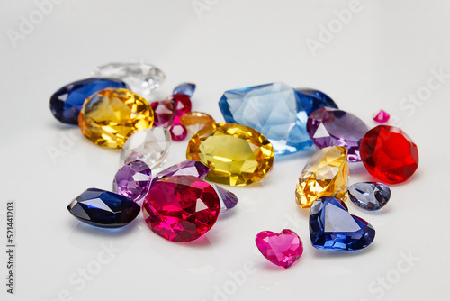 A scattering of precious stones on a light background  close-up.