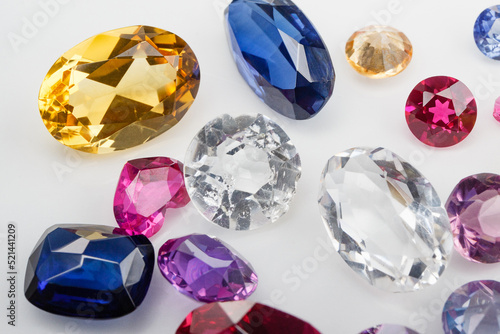 A scattering of precious stones on a light background, close-up.