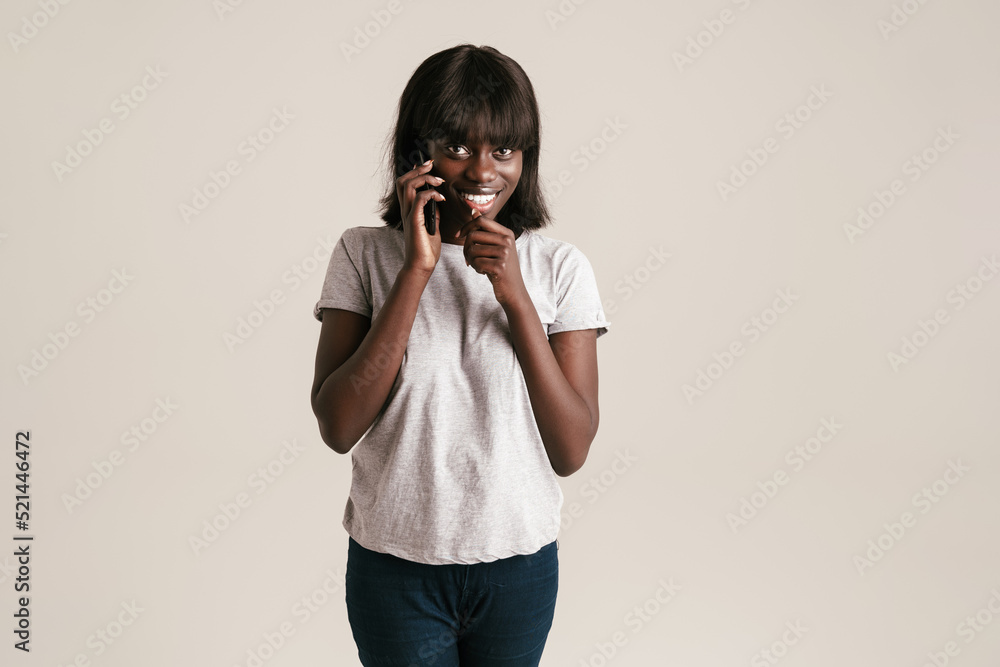 Young beautiful smiling african woman with bob haircut talking phone Young beautiful smiling african woman with bob haircut talking phone