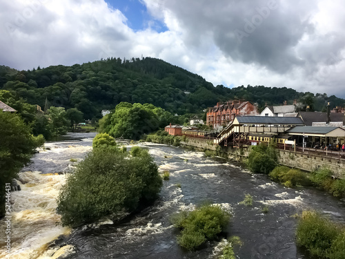 View of the turbulent River Dee and houses in the background. 