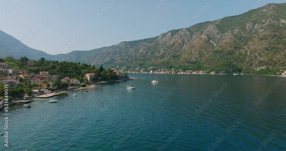 flying over a ship and passing by church in kotor bay flying over a ship and passing by church in kotor bay