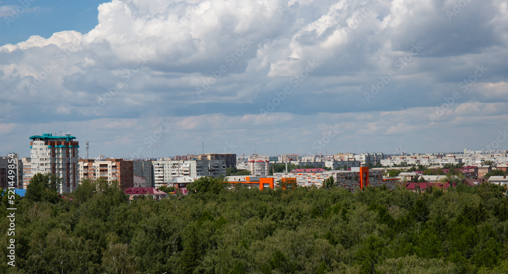 View of the buildings from the Ferris wheel in the park named after the 30th anniversary of the Komsomol of Omsk in summer View of the buildings from the Ferris wheel in the park named after the 30th anniversary of the Komsomol of Omsk in summer