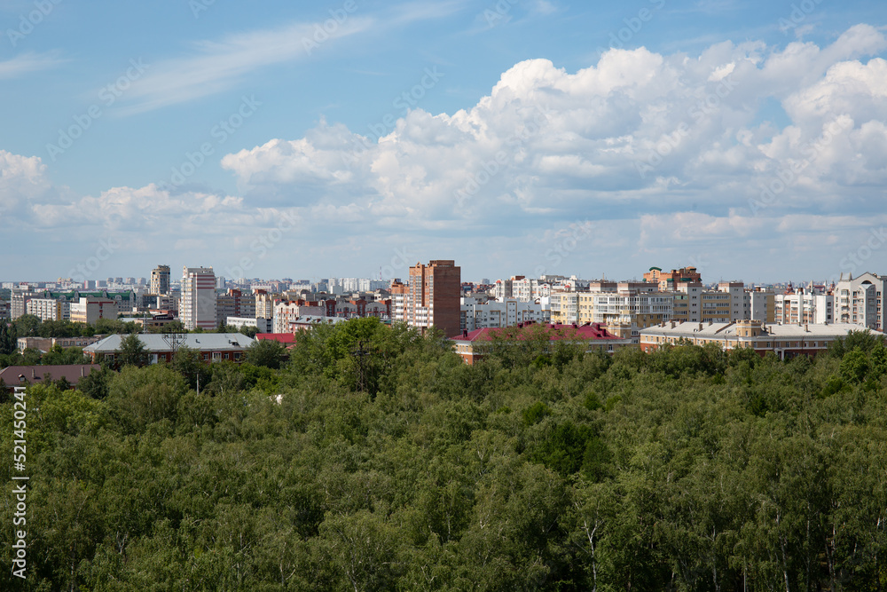 Fototapeta premium View of the buildings from the Ferris wheel in the park named after the 30th anniversary of the Komsomol of Omsk in summer