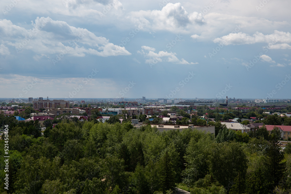 View of the buildings from the Ferris wheel in the park named after the 30th anniversary of the Komsomol of Omsk in summer