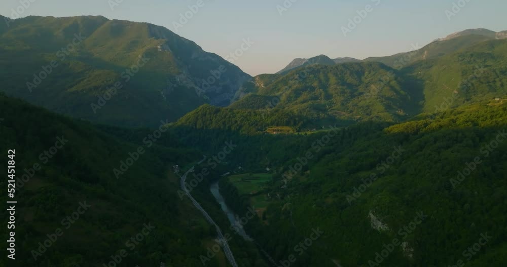 aerial view of sunrise in mountains with river in canyon aerial view of sunrise in mountains with river in canyon