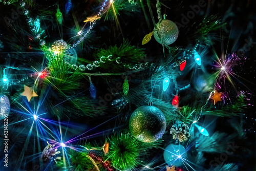 Christmas tree lights, multicolored garland in the dark on a holiday, close-up
