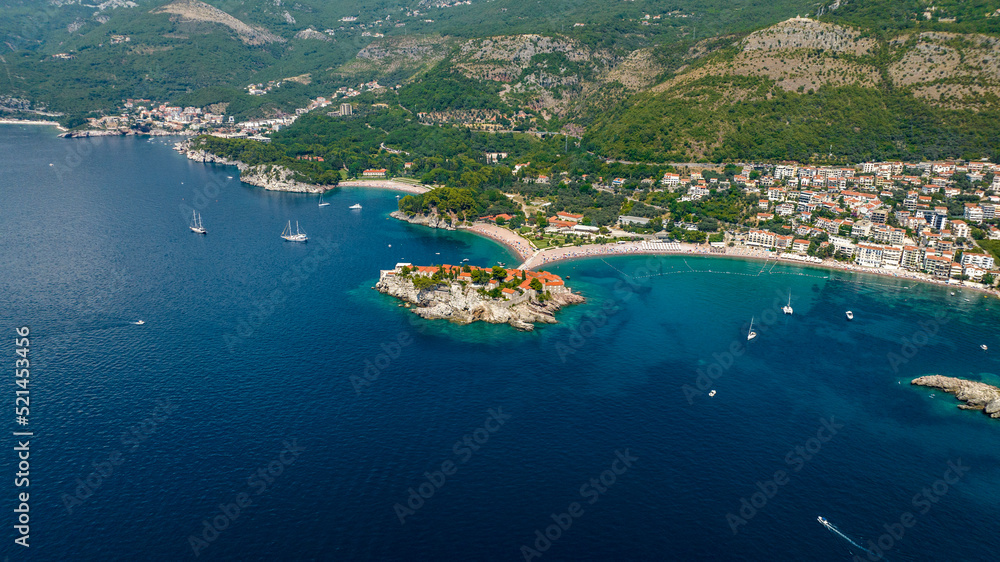 aerial view of sveti stefan island with mountains on background