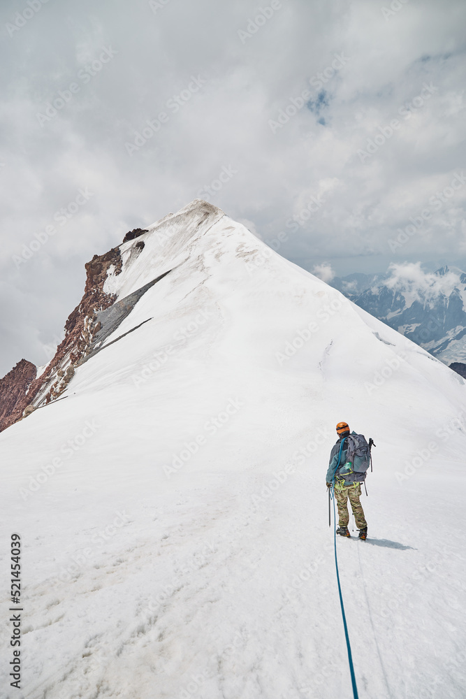 Climbing Kazbek, Georgia. male climber go to the summit.  Nature of Caucasian mountains. Mount Kazbek alpinist expedition