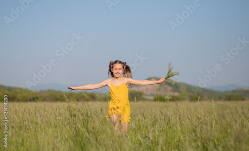 happy child girl running across the field 