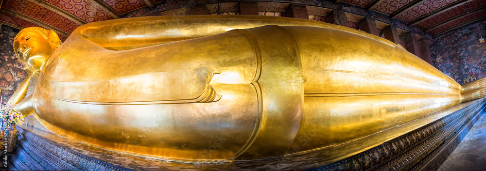 Panorama of big golden statue of Reclining Buddha in temple Wat Pho. Bangkok, Thailand