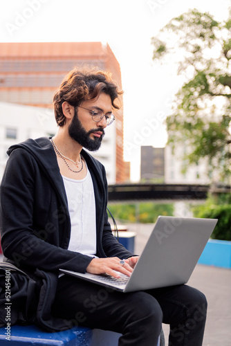 man working on his laptop at the university campus