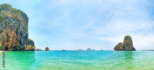 Tropical beach panorama landscape with clear water, rocky mountain and island in sea. Phra Nang beach, Thailand