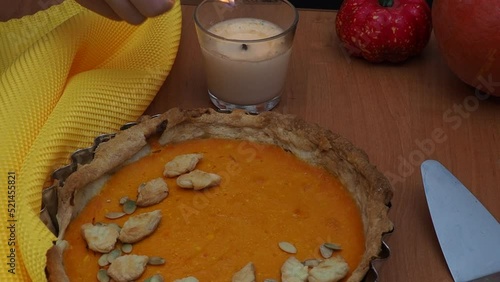 The girl is preparing a pumpkin pie at home for the holiday. Pumpkin pie with cream for Christmas or Thanksgiving holiday celebration. Homemade Pumpkin Pie for Thanksgiving Ready to Eat photo