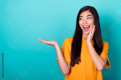 Photo of nice cute pretty girl with dressed yellow t-shirt impressed sale shopping look empty space isolated on teal color background