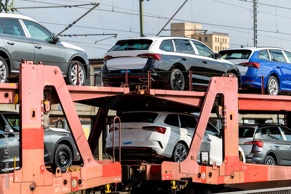 Mane new modern electric and fuel cars transportation by cargo freight train railway wagon. Railroad export and import automotive logistics service. Safety and insurance goods shipping insdustry Mane new modern electric and fuel cars transportation by cargo freight train railway wagon. Railroad export and import automotive logistics service. Safety and insurance goods shipping insdustry