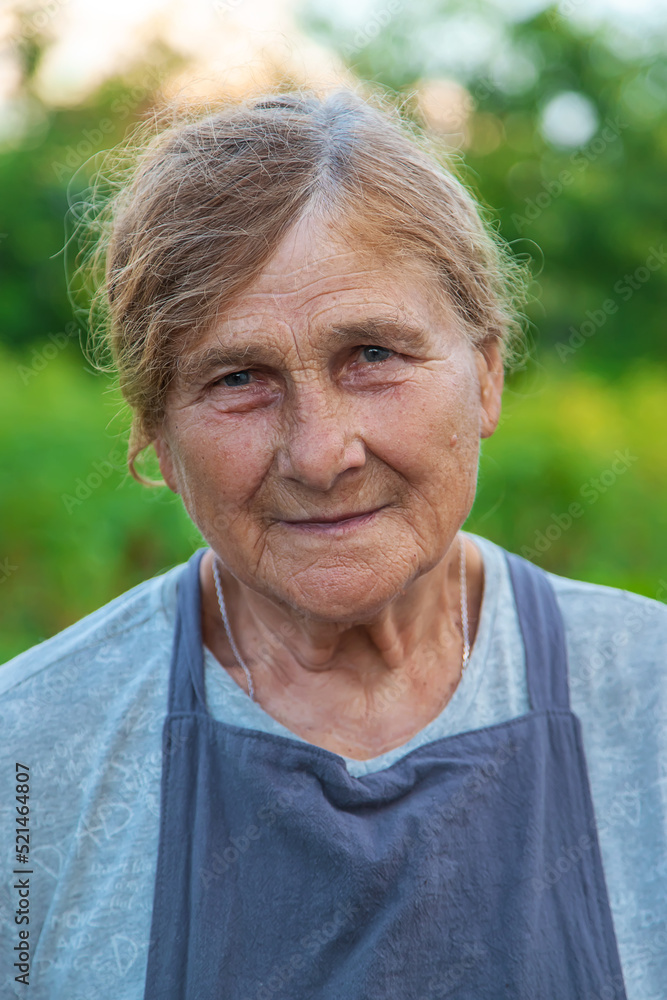 Portrait of a grandmother in the garden. selective focus. Portrait of a grandmother in the garden. selective focus.