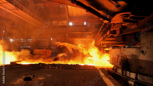 Hot steel being poured to the chute at the steel plant  heavy industry concept. Stock footage. Molten steel production in electric furnaces.