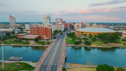 Drone footage over the Arkansas river running through the Wichita city downtown under the blue sky photo