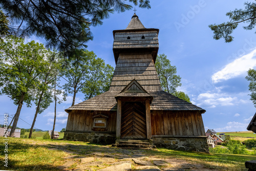 Old orthodox church surrounded by the trees on the hill at clear day.