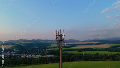 Aerial view of cellular transmitter tower mast during sunset