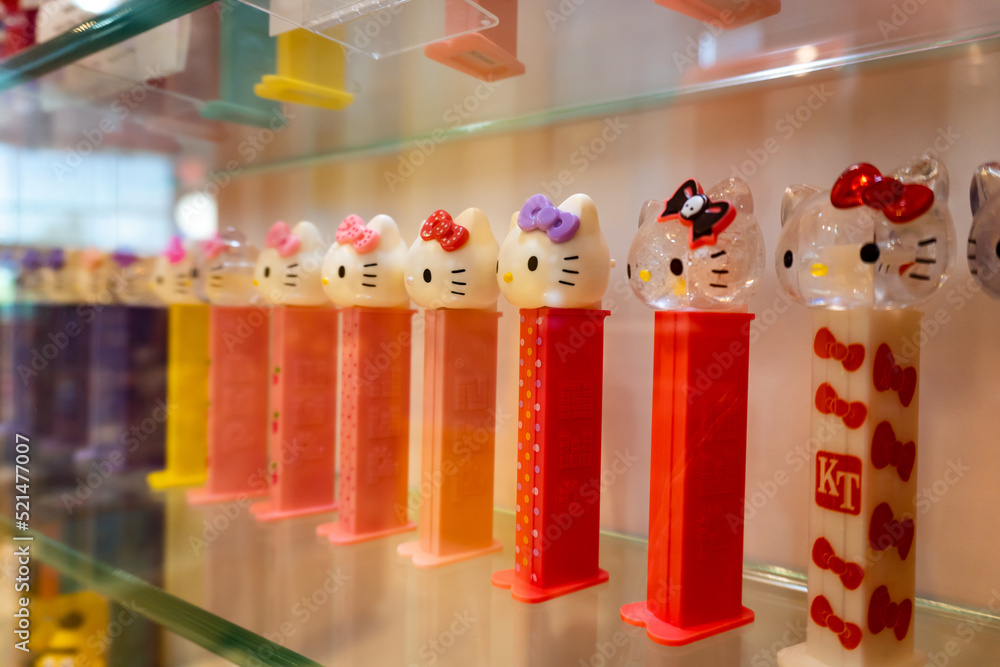 Hello Kitty PEZ dispensers at PEZ Visitor Center dedicated to all things PEZ  in Orange, Connecticut. Rainbow display of Hello Kitty PEZ dispensers.  Sanrio brand of candy dispenser on glass shelf. Stock