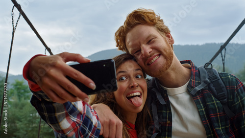 Couple travelers taking selfie in mountains nature. Friends hugging each other.
