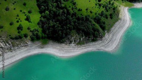 Beautiful nature, landscape of the mountain lake Kezenoi am, Russia, Chechnya, flying above the clouds, aerial view. photo