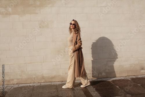 Fotografija portrait of a style woman walking, enjoys a wonderful atmosphere of a vacation in fall time
