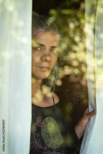 woman looking through a window