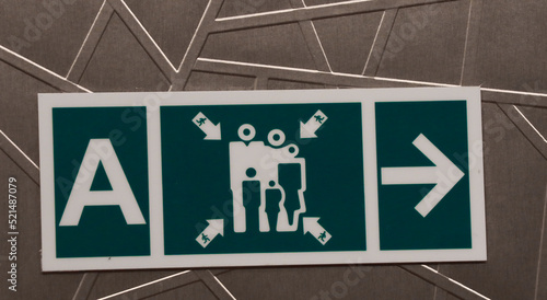 Muster station sign directing passengers to the life boats